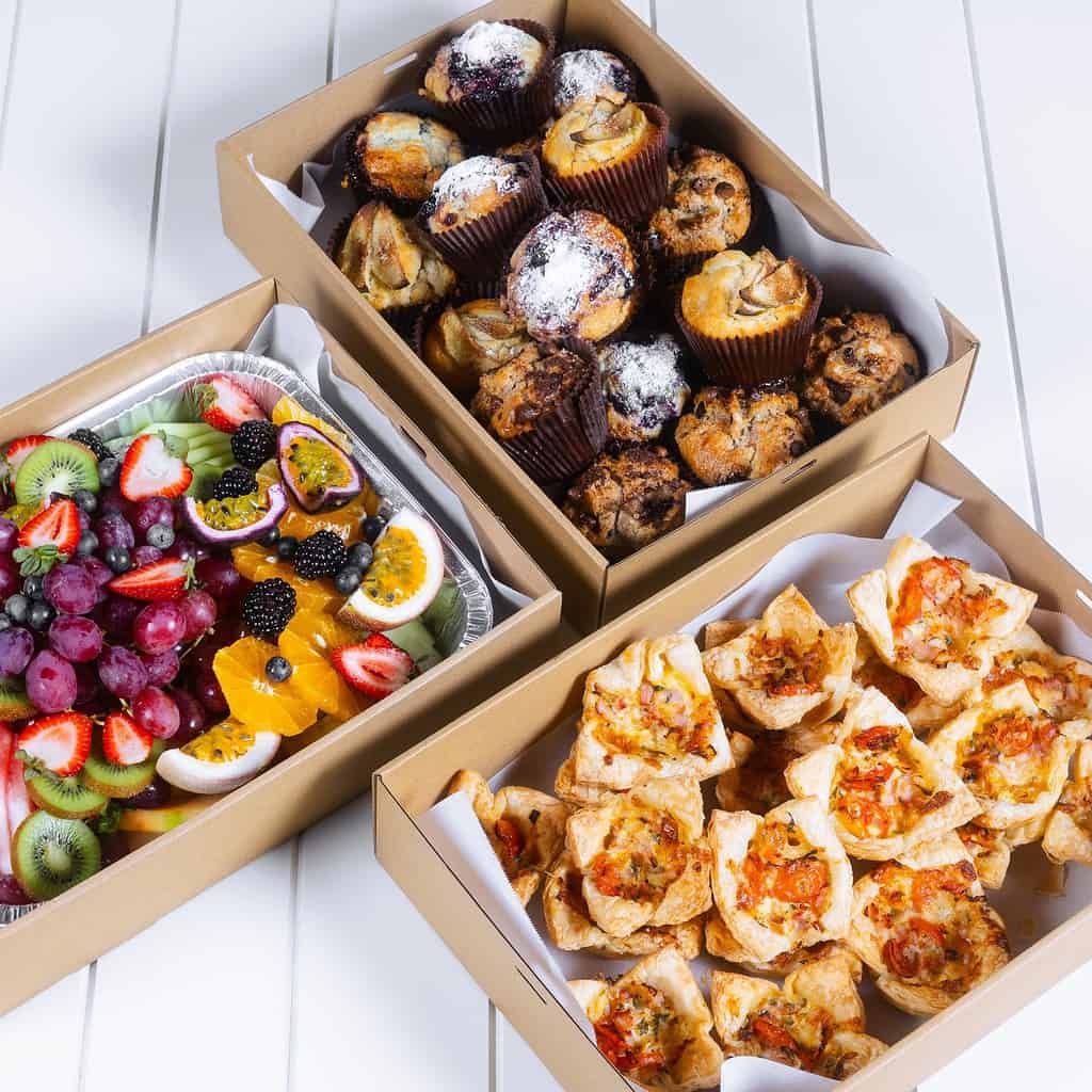 Assorted baked goods and fresh fruit in boxes from The Moody Chef.