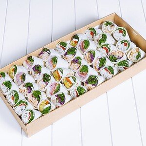 Assorted fresh wraps with colorful ingredients in a box.