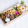 Gourmet Middle Eastern mezze platter with dips, bread, and vegetables.