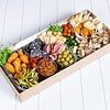Gourmet antipasto platter with cheeses, meats, olives, and vegetables.