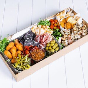 Gourmet antipasto platter with cheeses, meats, olives, and vegetables.
