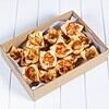 Mini cheese & bacon Quiche in a box on white surface.