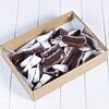 Chocolate brownies in a box with powdered sugar on top.
