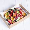 Colorful fresh fruit platter with strawberries, kiwi, grapes, and citrus slices.