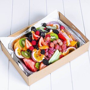 Colorful fresh fruit platter with strawberries, kiwi, grapes, and citrus slices.