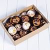 Variety of freshly baked muffins with berries and powdered sugar in a box.
