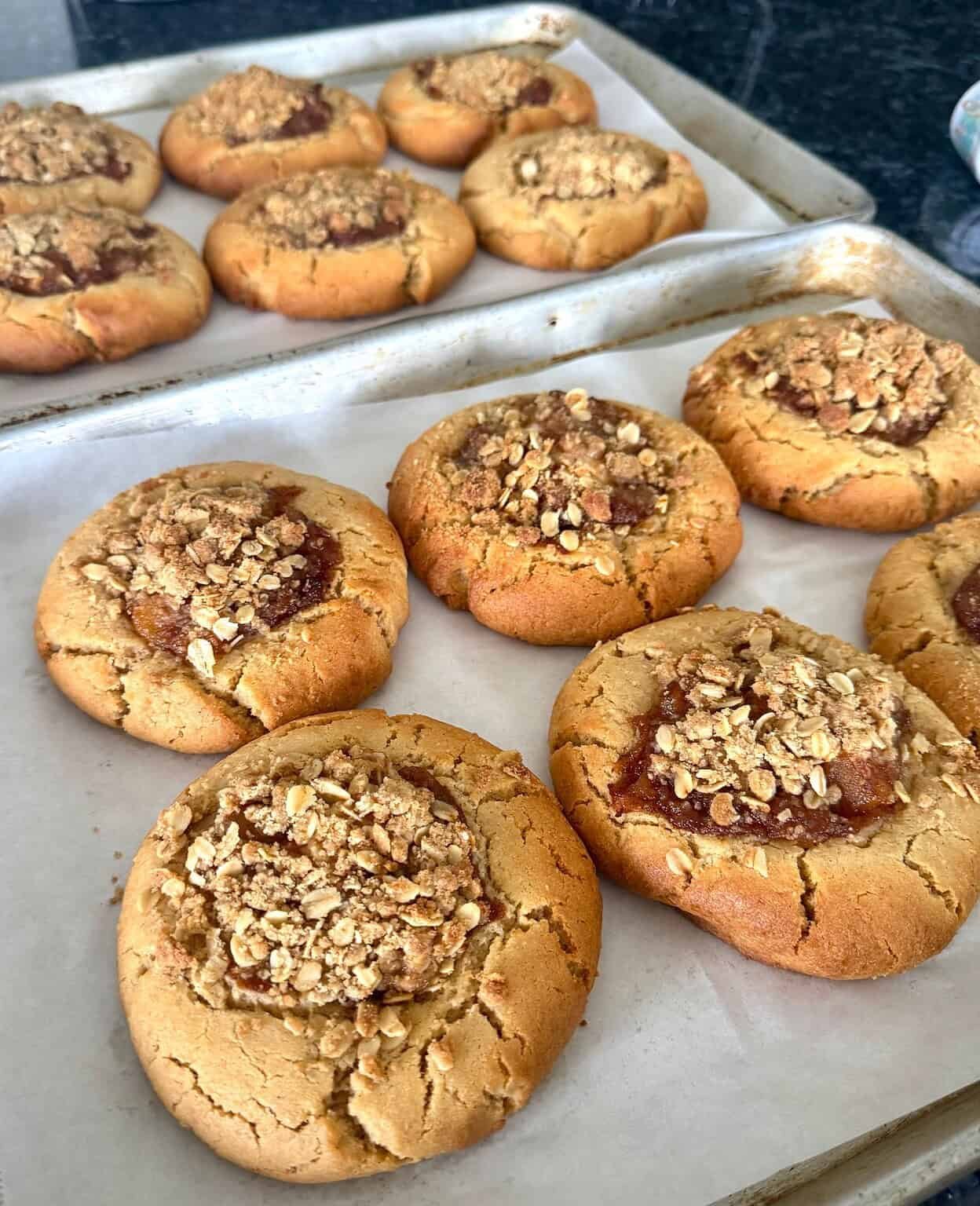Freshly baked oatmeal jam cookies with crushed nuts on top.